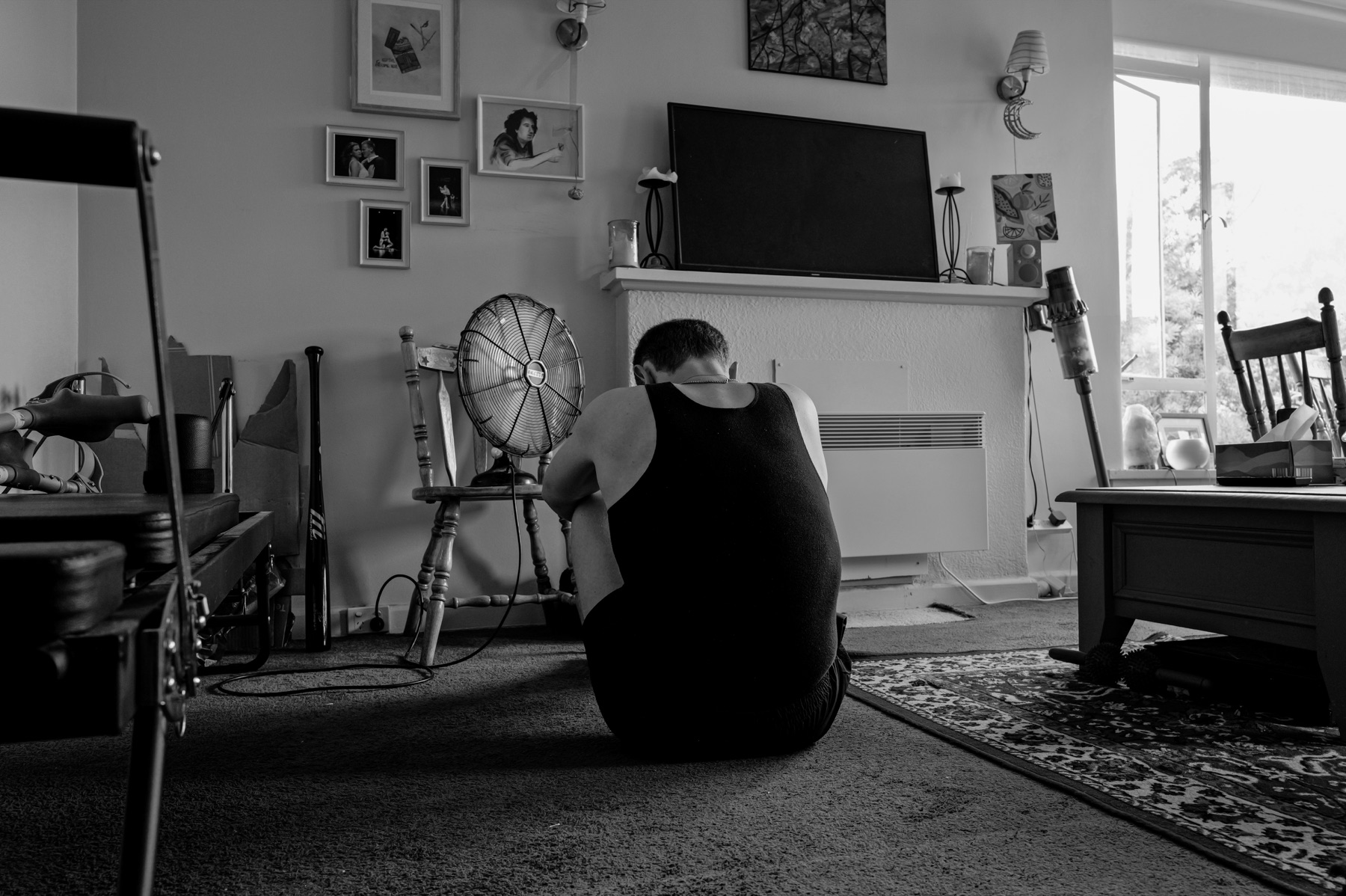 Actor seated alone on a bedroom floor