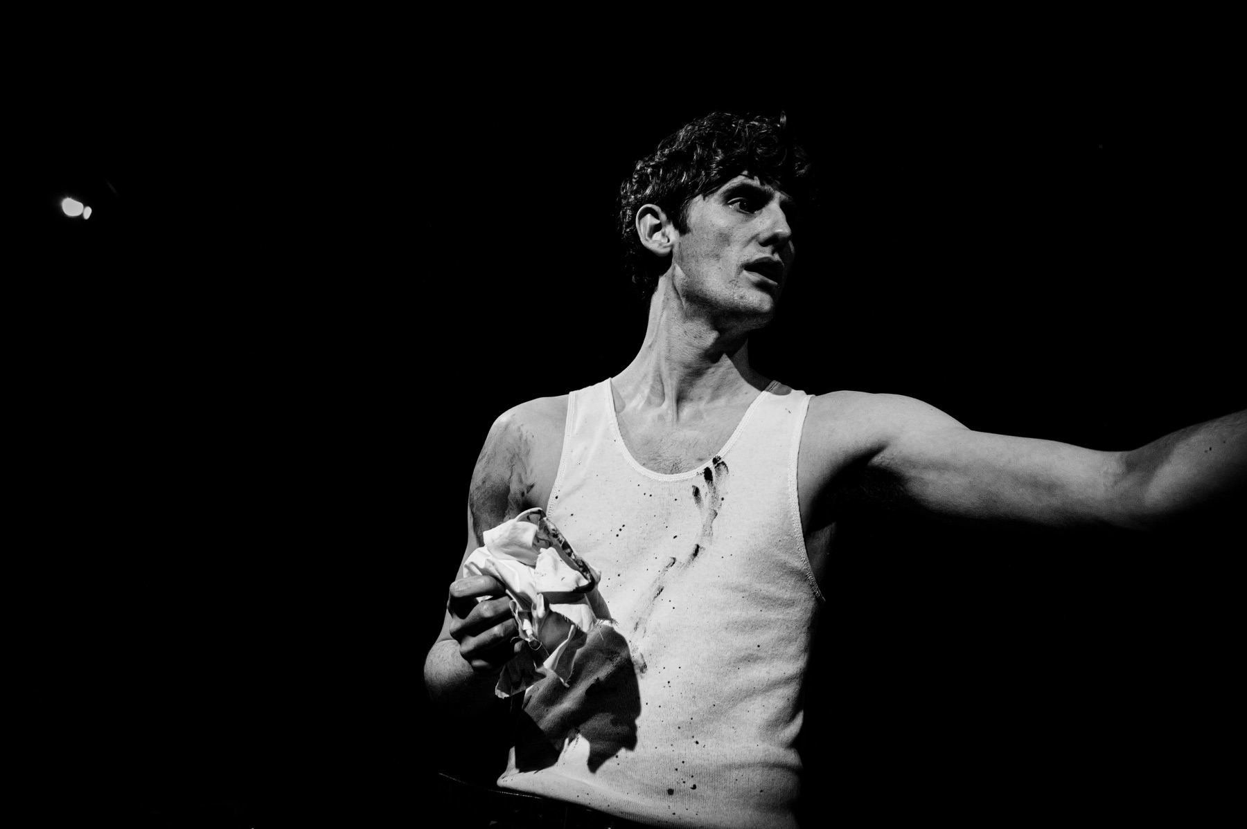 Red performer gesturing with a cloth in hand